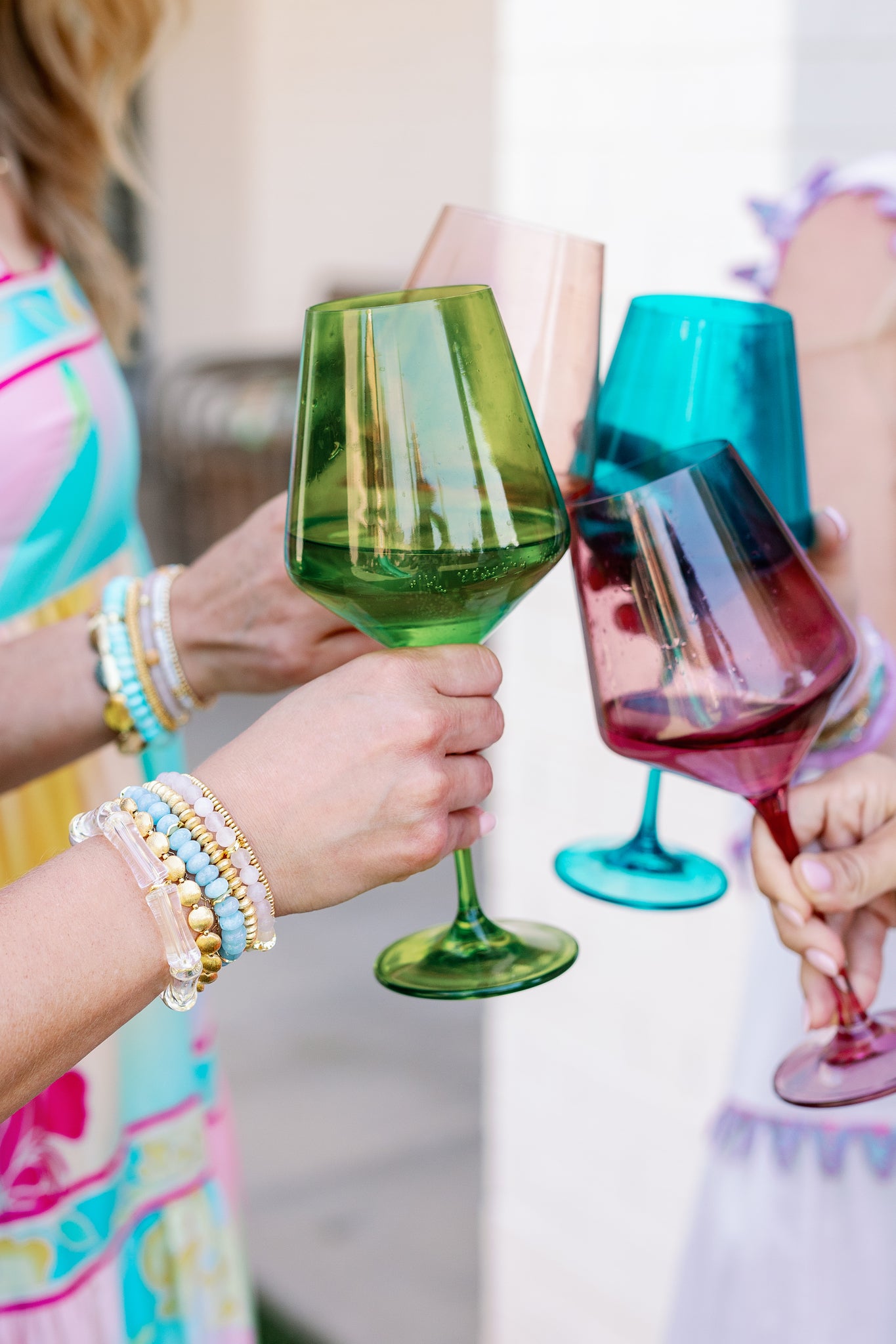 elegant bracelets on wrist while holding wine glass