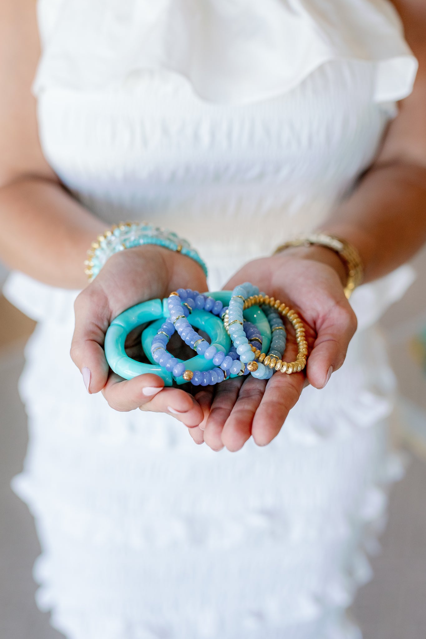handful of bracelets of all different sizes and materials