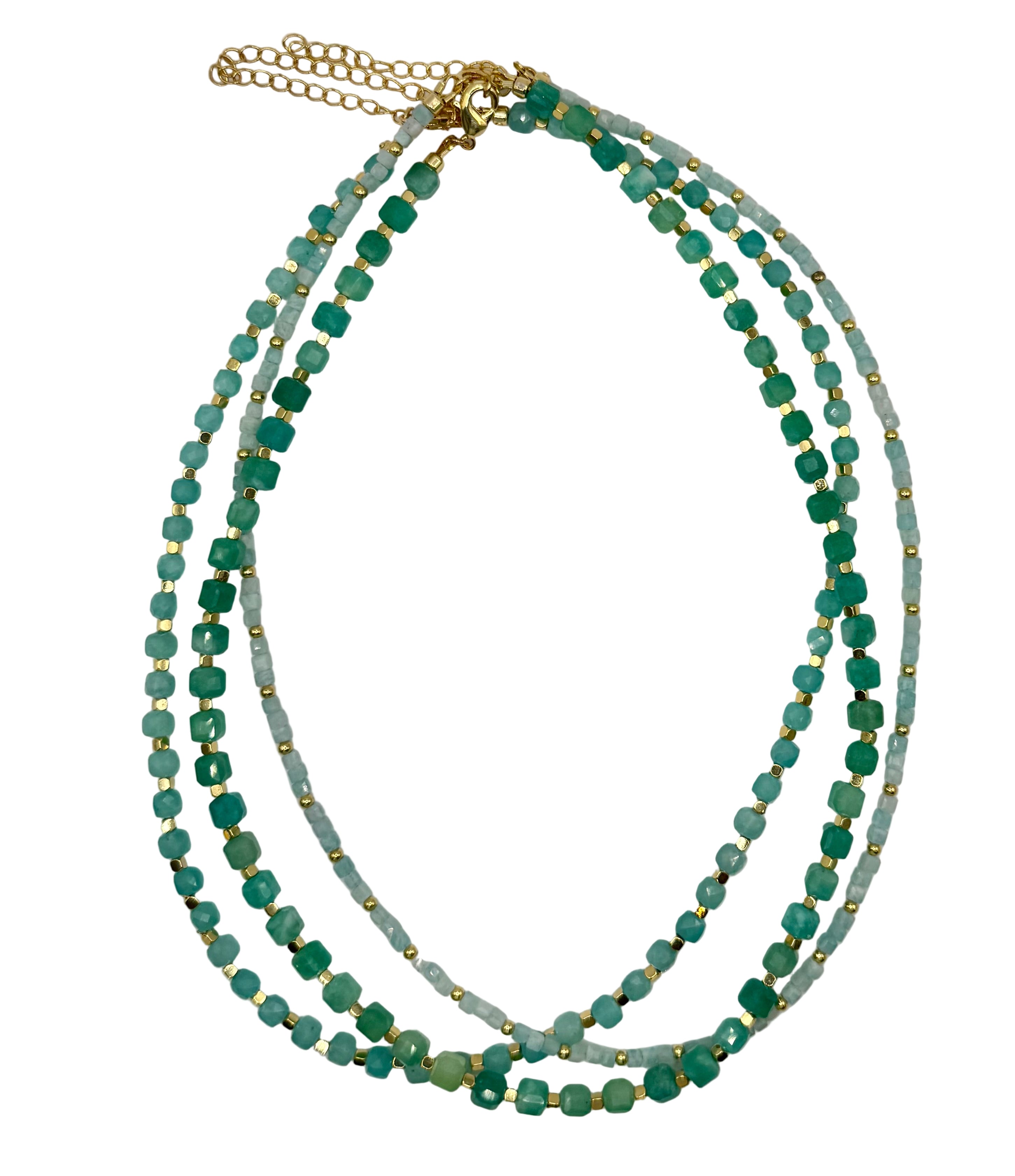 Multistrand necklace with green beads and gold accents on a light gray background